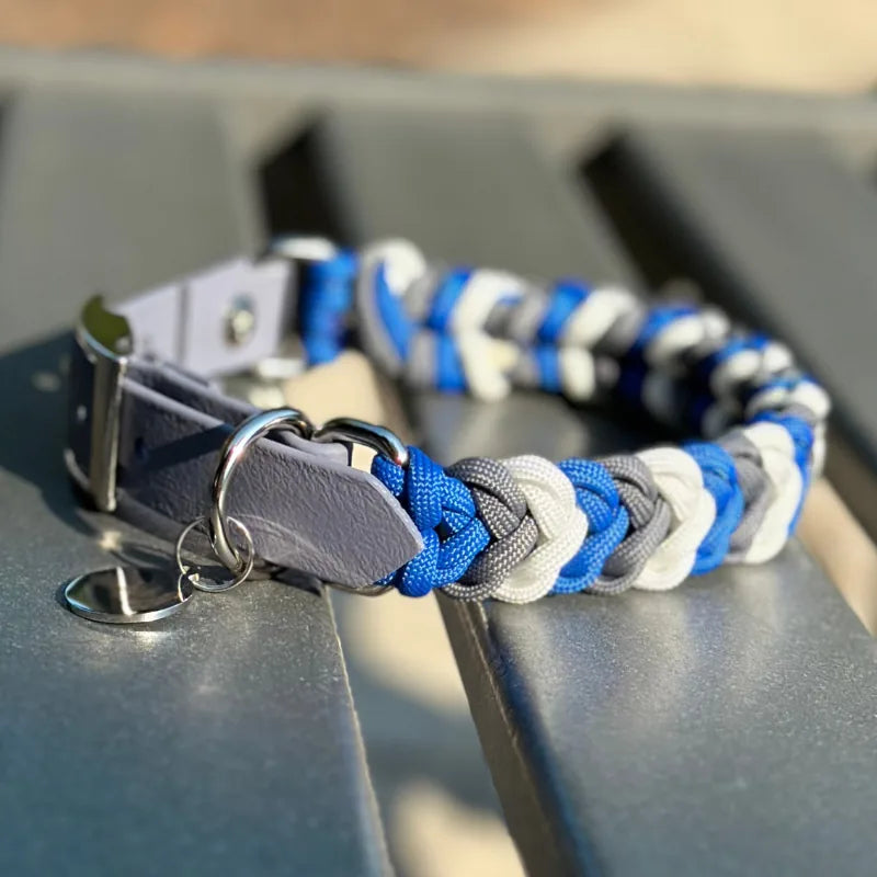 Handmade dog collar in braided royal blue, graphite, and white nylon, featuring a gray adjustable strap and sturdy D-ring.