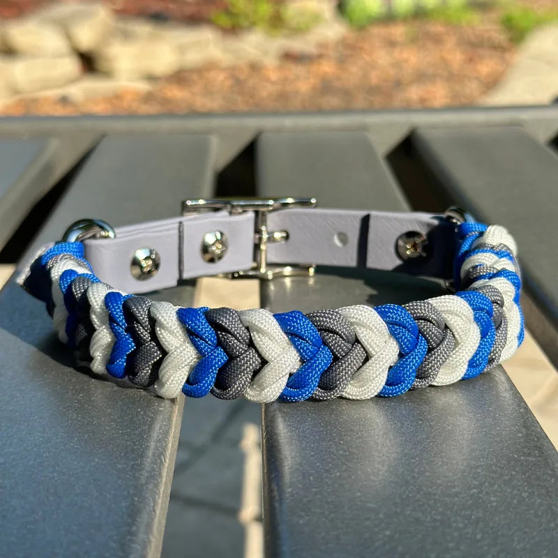Hand-braided dog collar in royal blue, graphite, and white, featuring a nickel-plated buckle and adjustable fit strap.