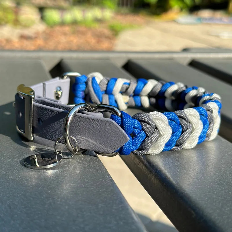 Hand-braided dog collar in royal blue, graphite, and white, featuring a gray adjustable strap and nickel-plated buckle.