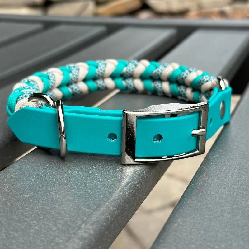 Handmade braided dog collar featuring a teal and cream pattern, with an adjustable BioThane® fit and nickel-plated buckle.