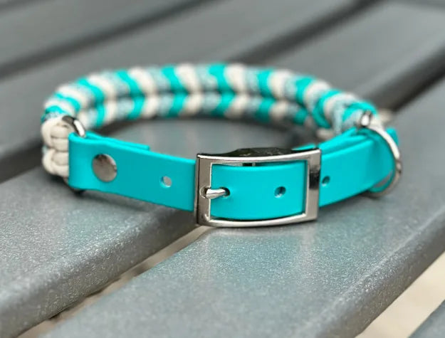 Handmade braided dog collar featuring a teal and cream pattern, adjustable BioThane® fit, and sturdy D-ring.