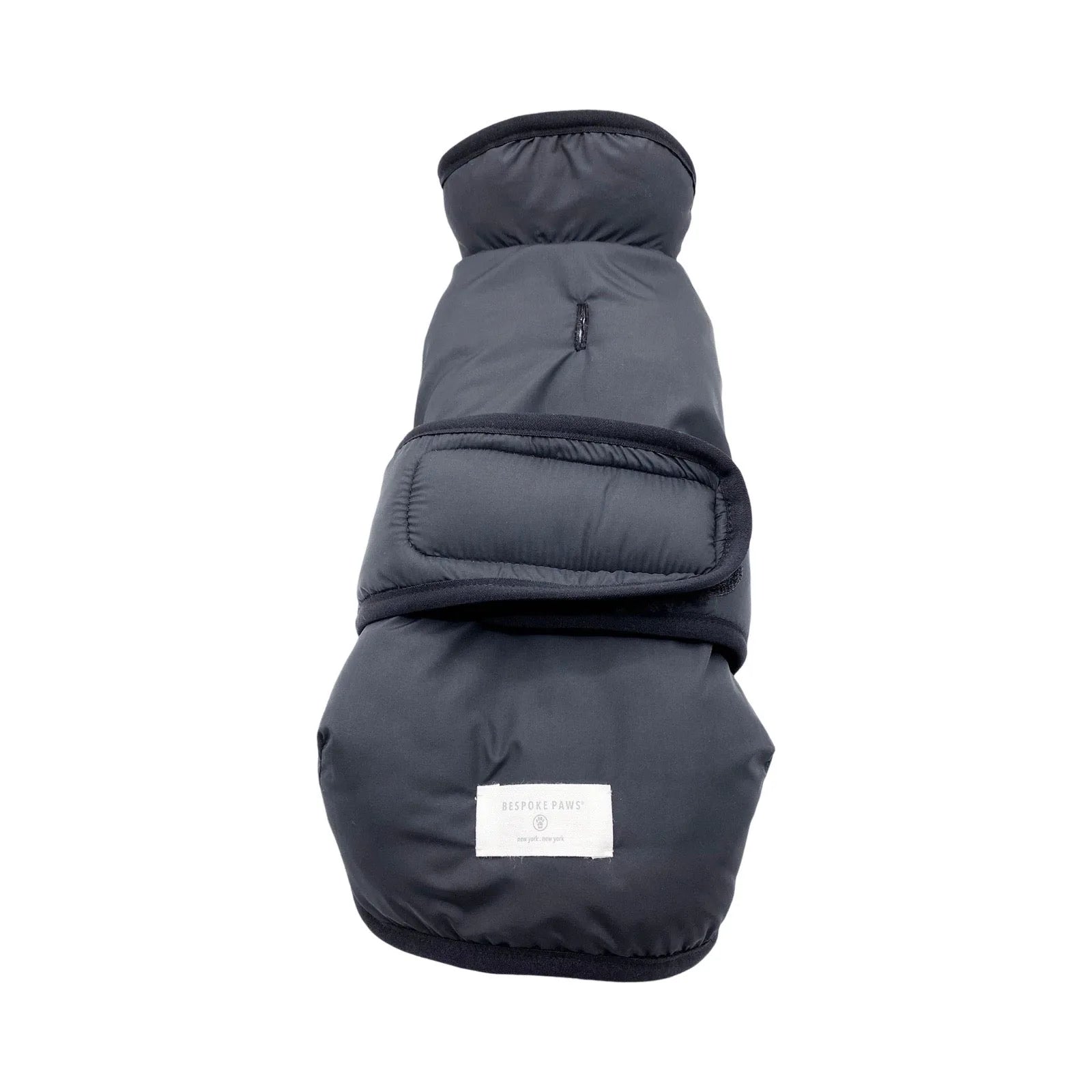 Cozy black faux shearling dog vest with adjustable straps, featuring a label from BESPOKE PAWS. Ideal for chilly days.