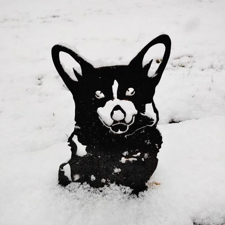 Black Corgi metal silhouette in snow, showcasing detailed features, perfect for outdoor garden decor.
