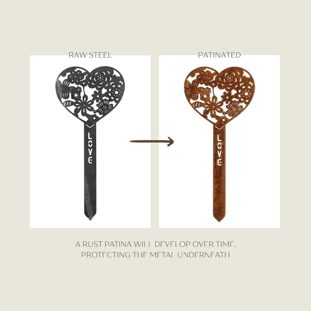 Heart-shaped garden stake in raw and patinated Corten steel with intricate floral design and "LOVE" engraving.