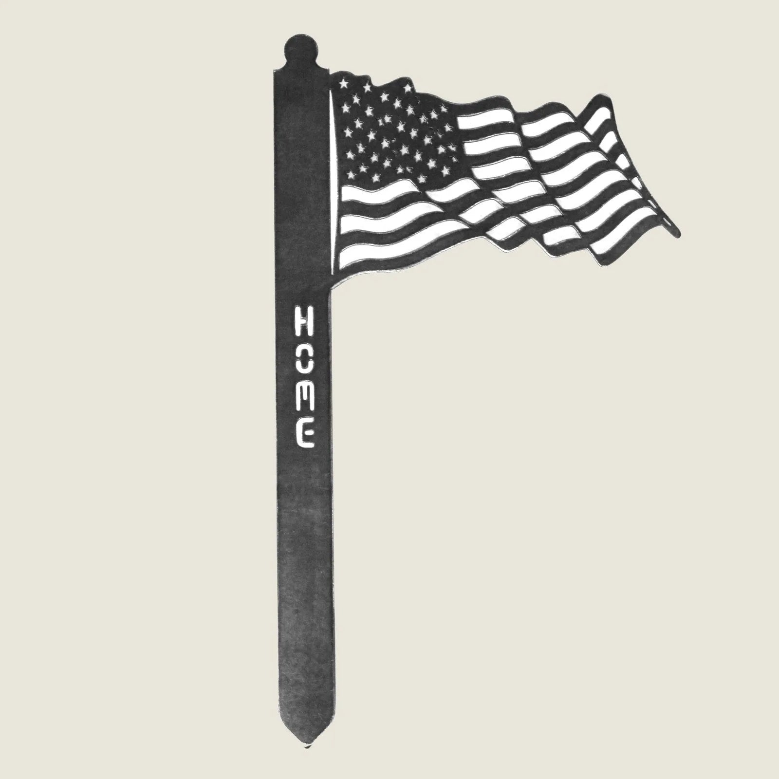 Corten steel garden stake featuring a waving US flag design with "HOME" text, adding rustic charm to outdoor spaces.