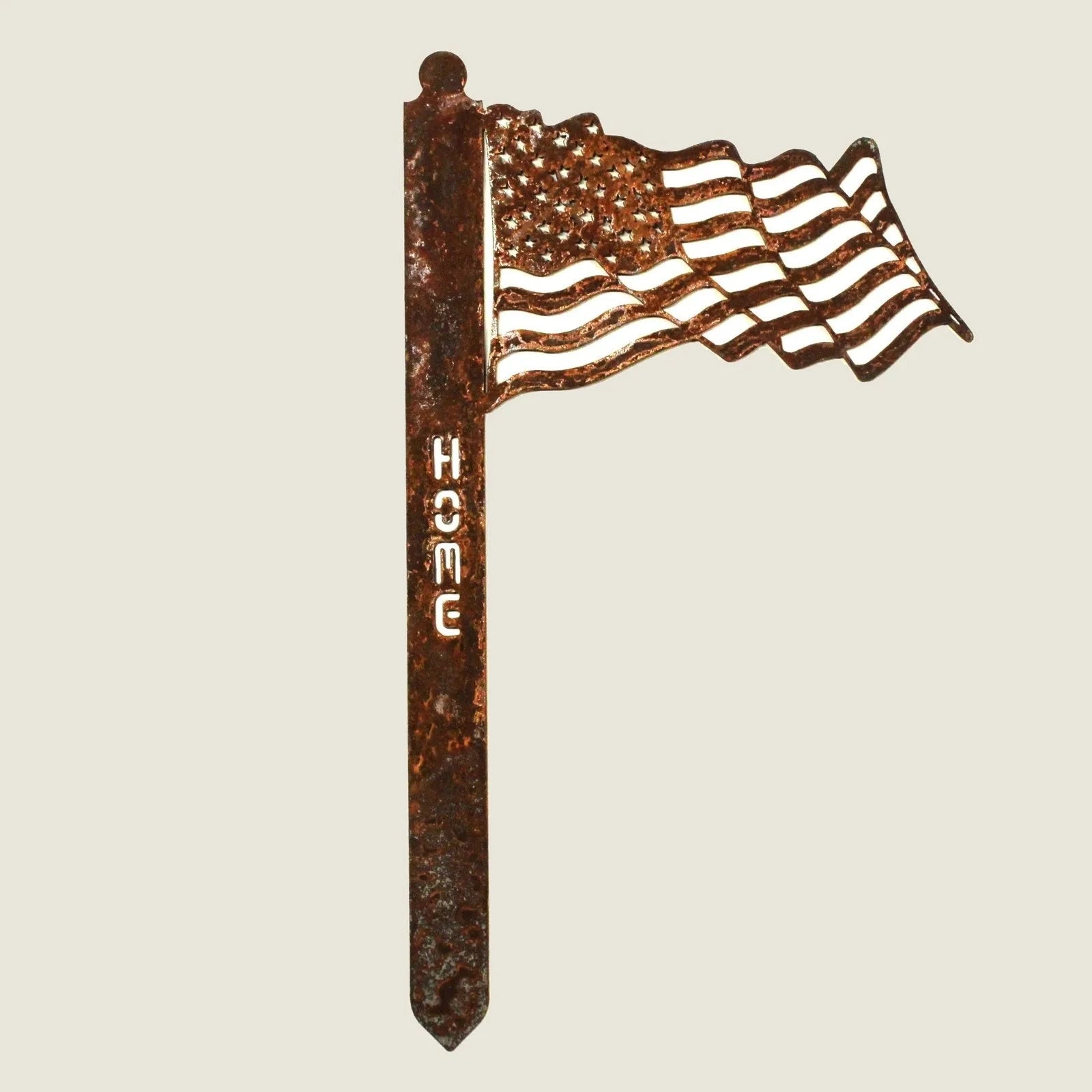Corten steel garden stake featuring a waving US flag with "HOME" embossed, perfect for patriotic outdoor decor.