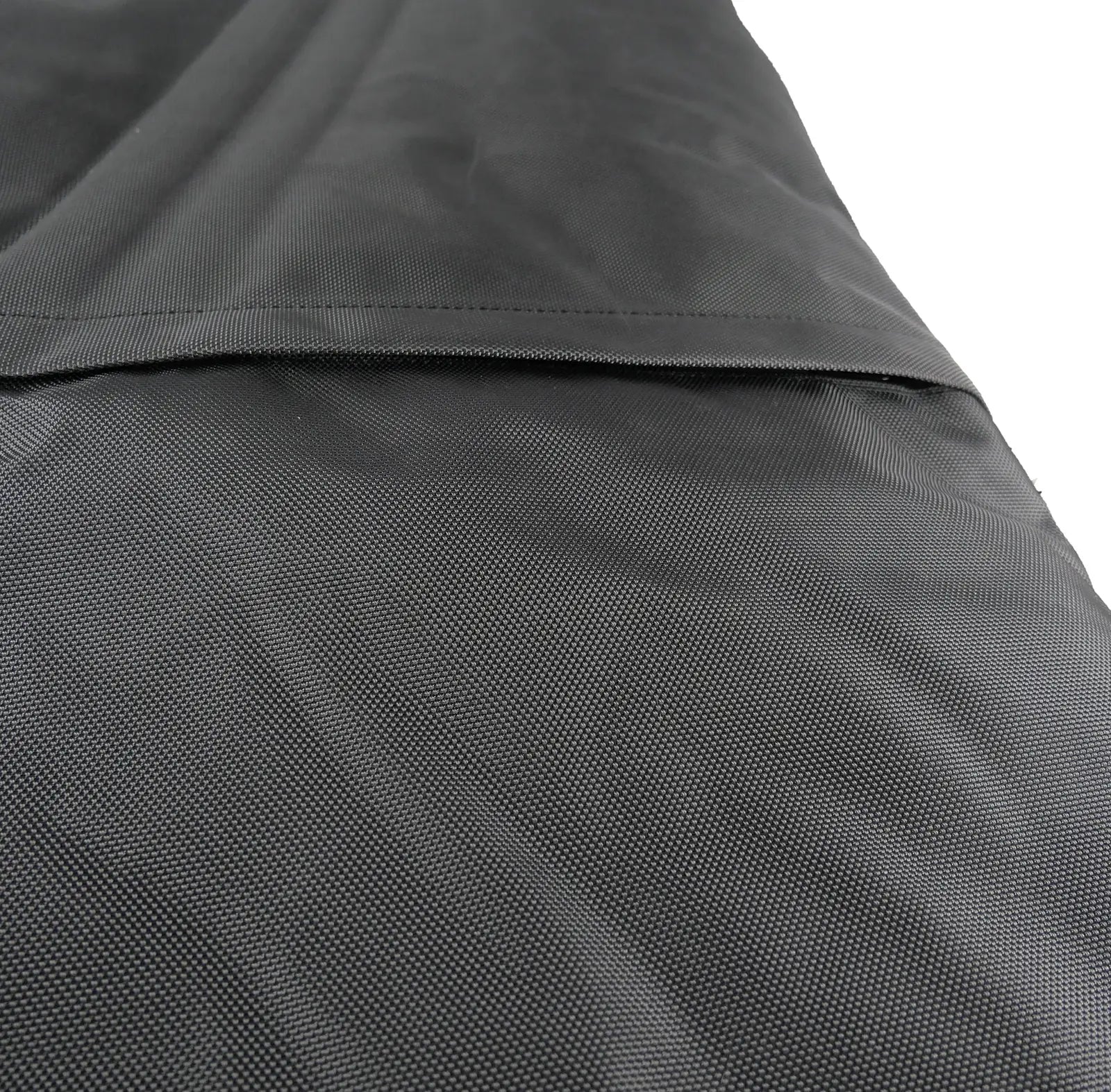 Durable black crate pad with a textured ballistic nylon cover, designed for comfort and long-lasting use.