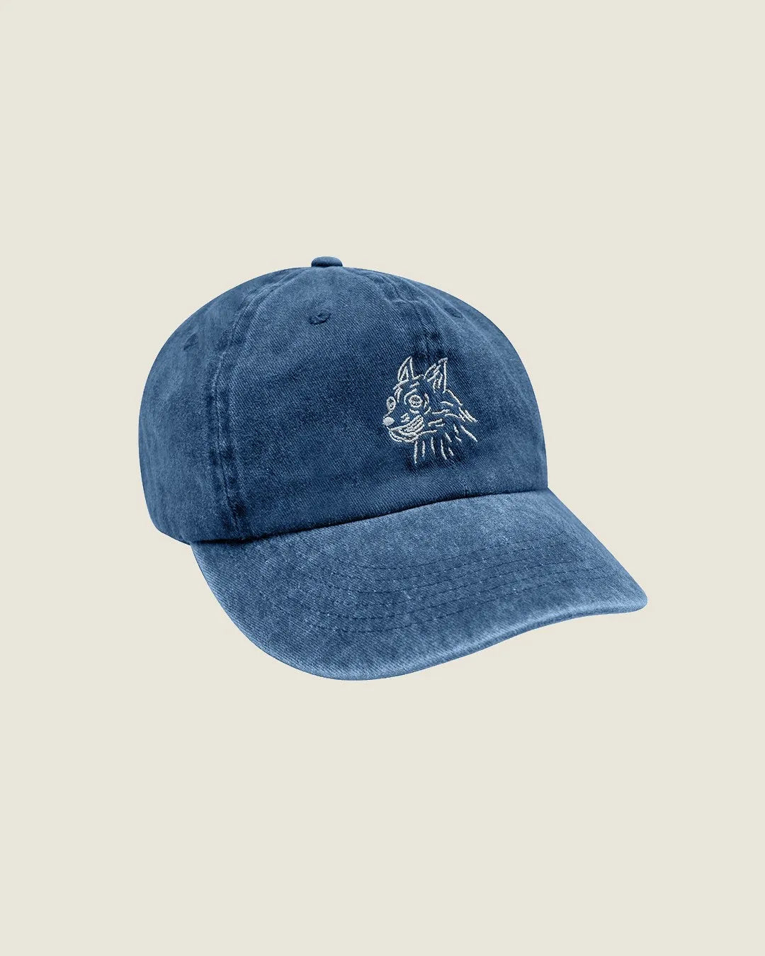 Faded royal cap featuring an embroidered dog design and adjustable strap for a comfortable fit.