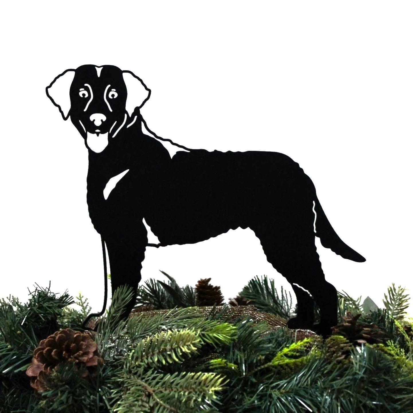 Curly Coated Retriever metal silhouette in black, standing amidst greenery and pine cones, showcasing outdoor dog decor.