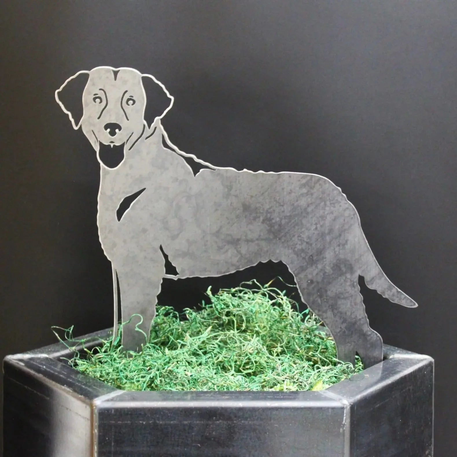 Curly Coated Retriever metal silhouette in gray, displayed on green moss in a decorative planter.