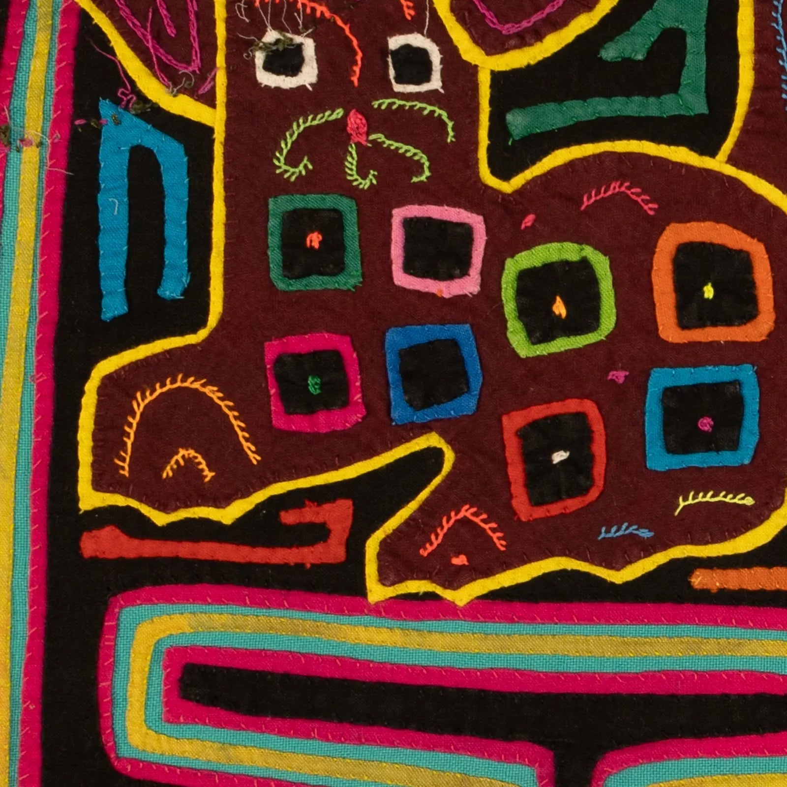 Hand-stitched decorative tapestry featuring a colorful puppy design, vibrant appliqué patterns on dark fabric.