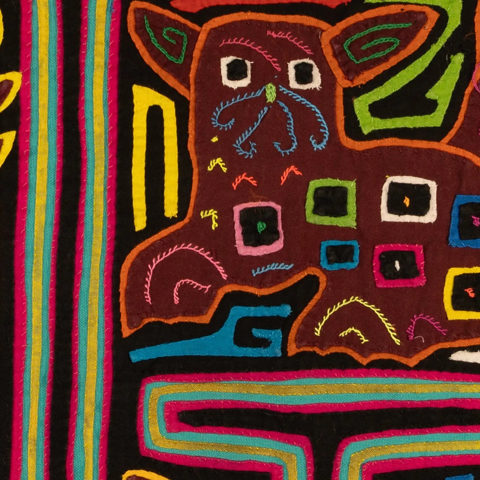Hand-stitched tapestry featuring a playful puppy design in vibrant colors on a dark background.