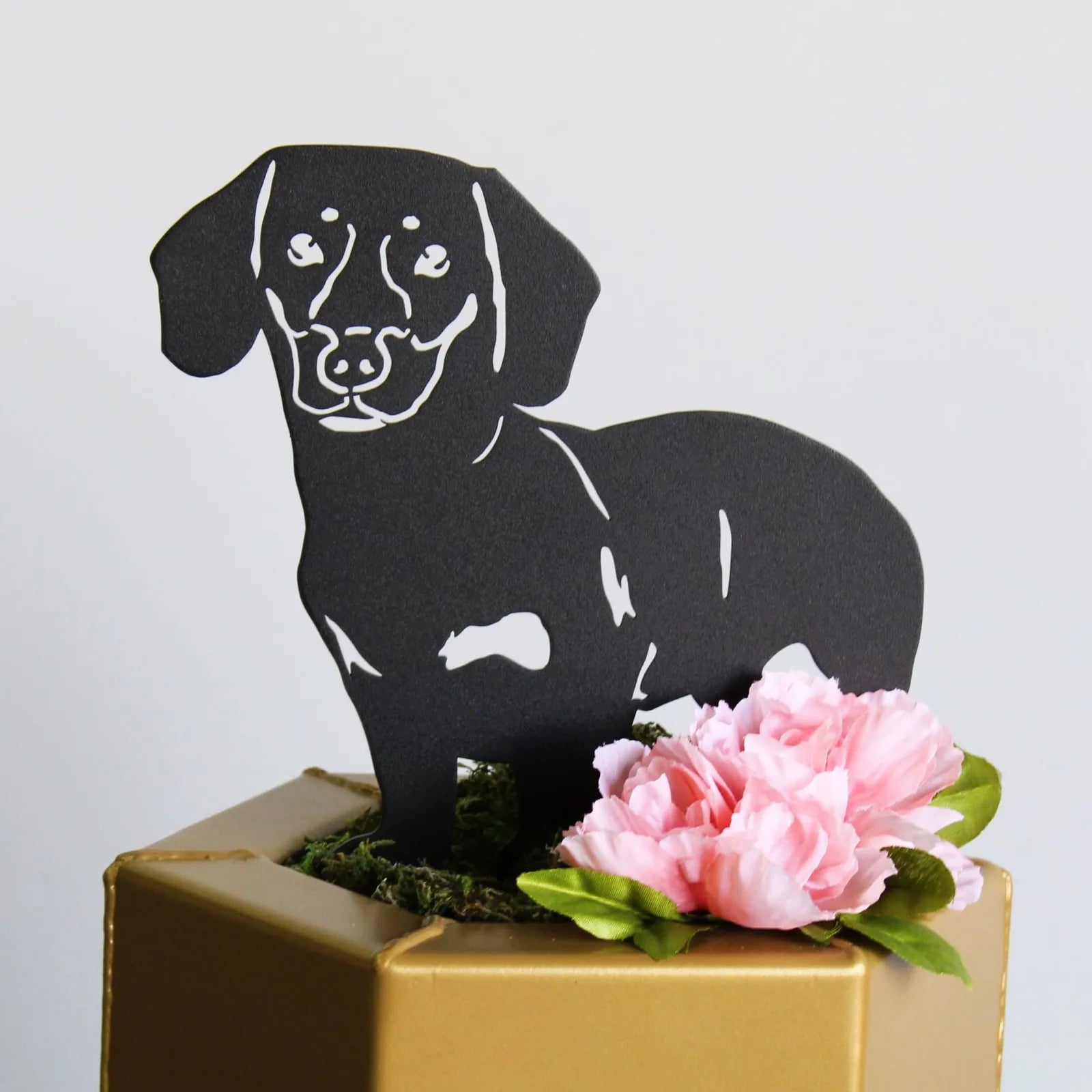 Handcrafted black metal silhouette of a Dachshund with pink flowers, perfect for dog-themed decor.