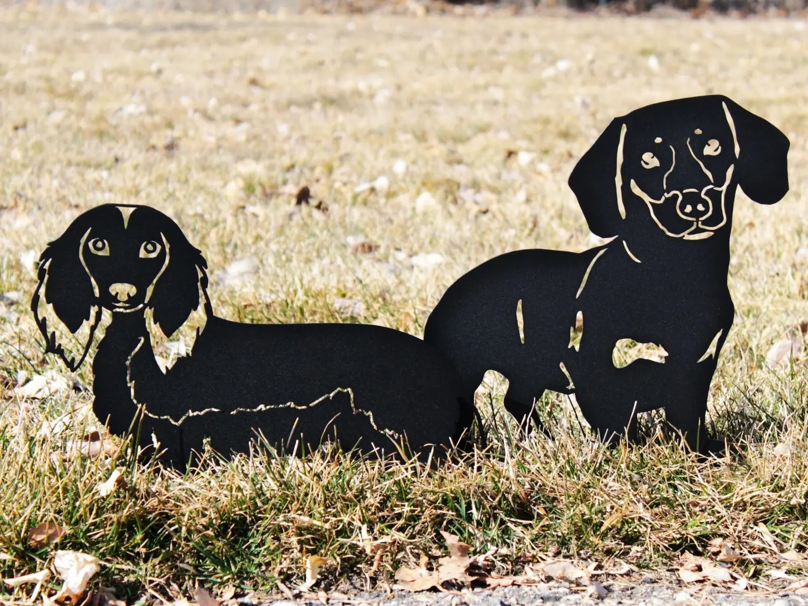 Handmade black metal silhouette of two Dachshunds, perfect for outdoor garden decor or indoor display.