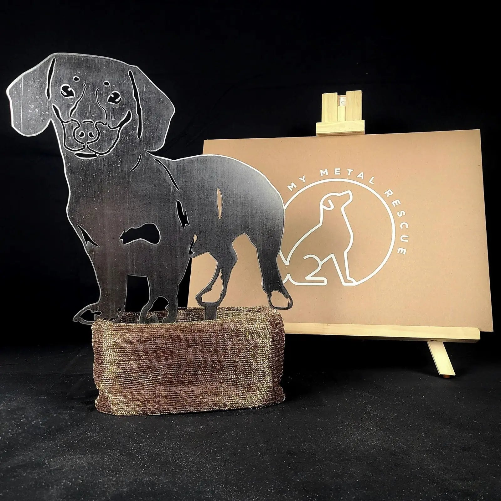 Handmade metal silhouette of a Dachshund in silver, mounted on a textured base, against a My Metal Rescue backdrop.