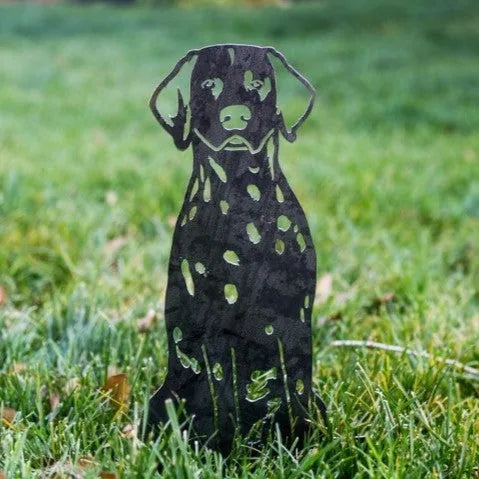 Dalmatian silhouette in matte black metal standing on lush green grass, showcasing its weather-resistant design.
