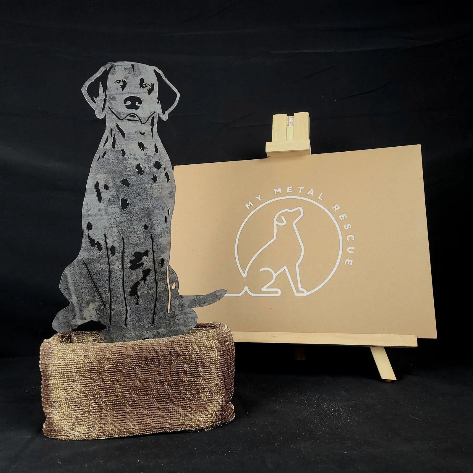 Dalmatian silhouette in weathered Corten steel, displayed on a textured base with a neutral backdrop.