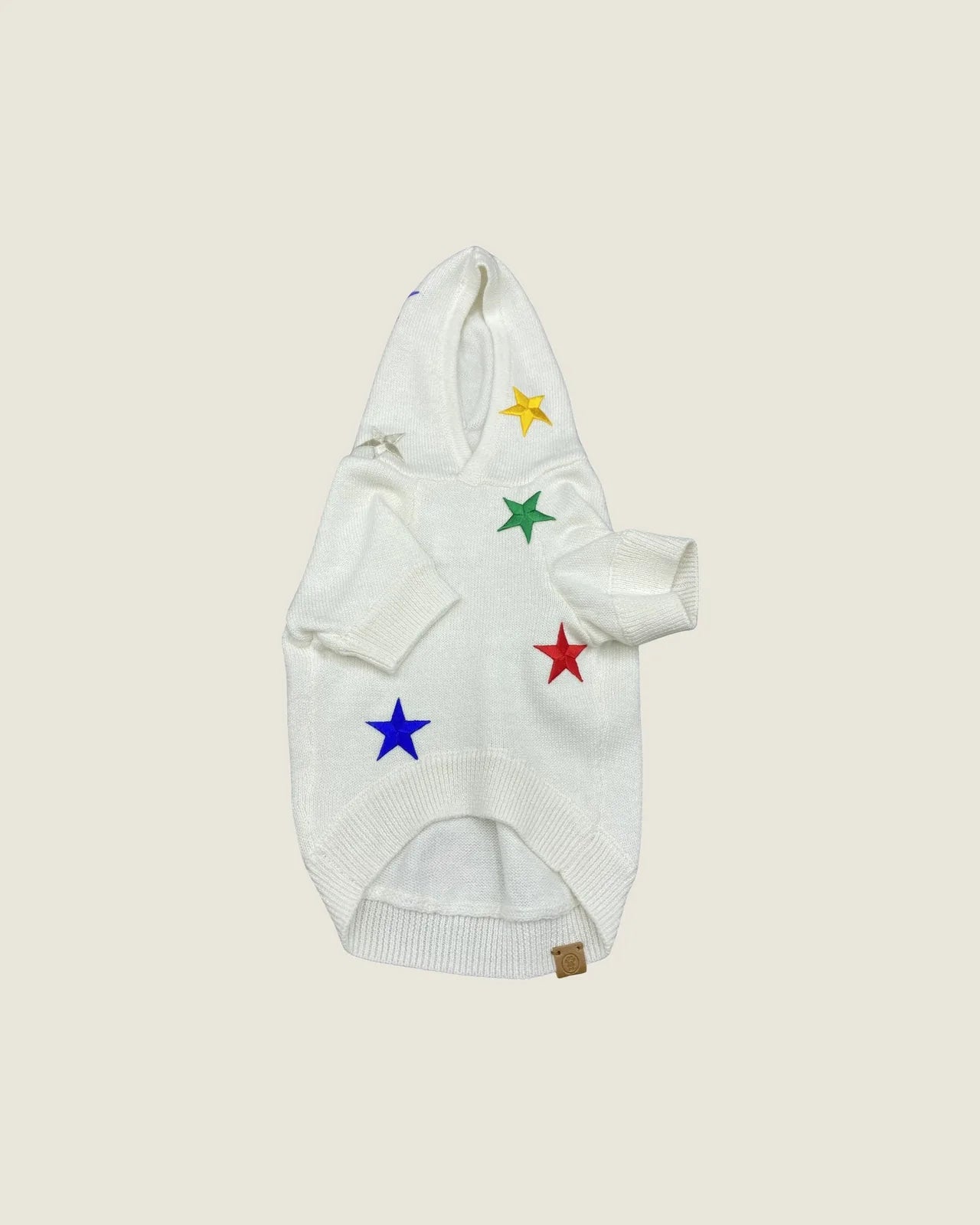 Cozy white hoodie for small dogs, featuring colorful star patches in yellow, green, red, and blue on soft knit fabric.