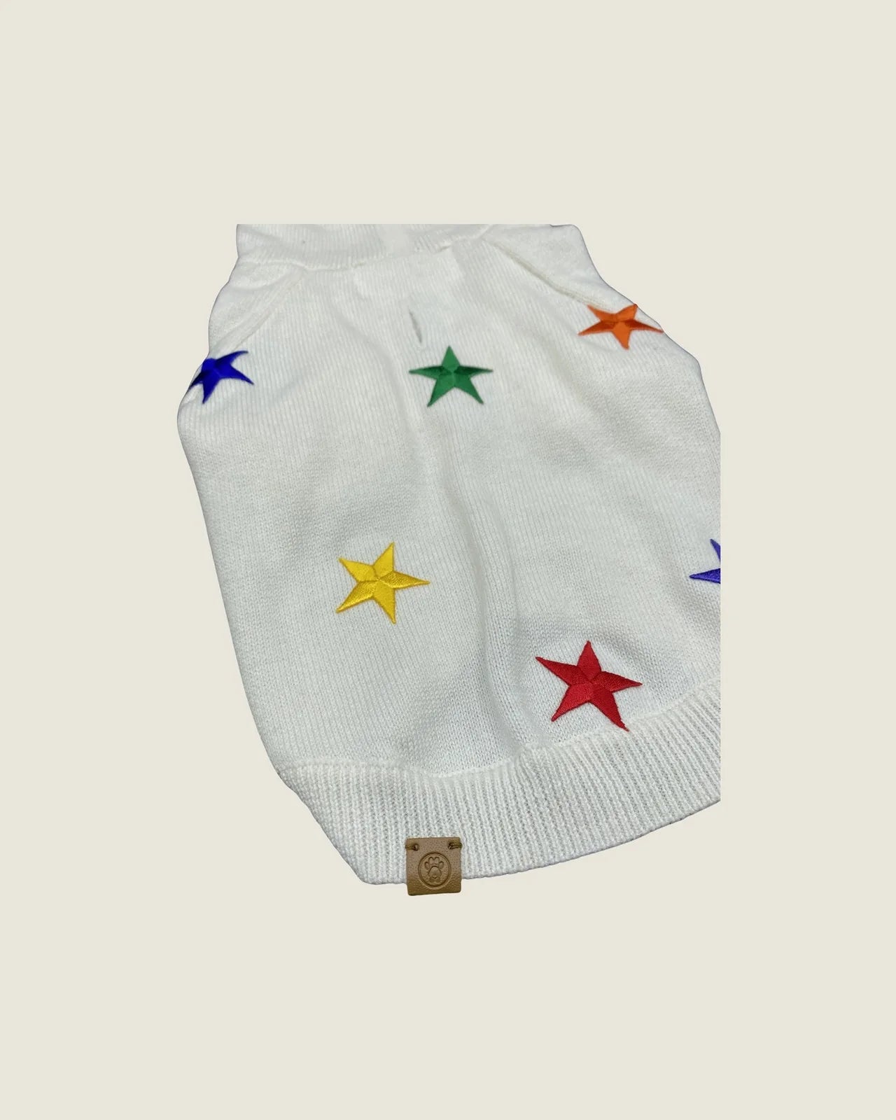 Cozy white dog hoodie featuring vibrant rainbow star patches, made from soft cotton-blend fabric for small dogs.