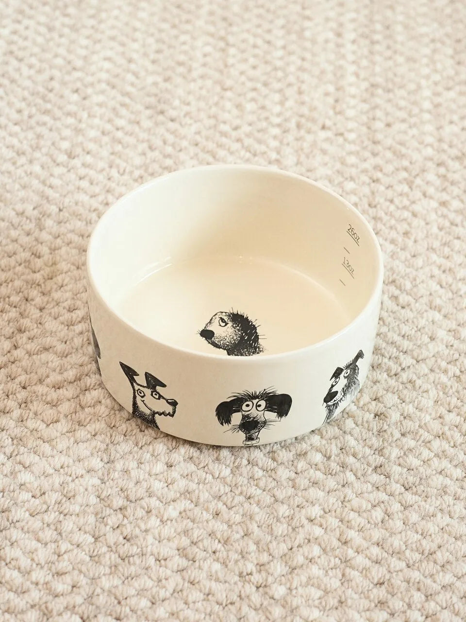 Ceramic DERPY BOWL with playful dog illustrations, featuring a non-slip base and smooth interior in an off-white color.