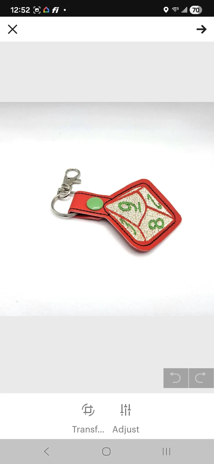 Handmade red dice keychain featuring a 10-sided die design with green numbers and a silver keyring attachment.