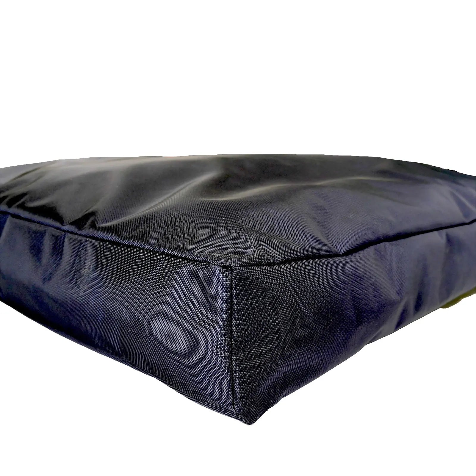Durable black orthopedic dog bed with a rugged nylon cover and supportive core, designed for comfort and stability.