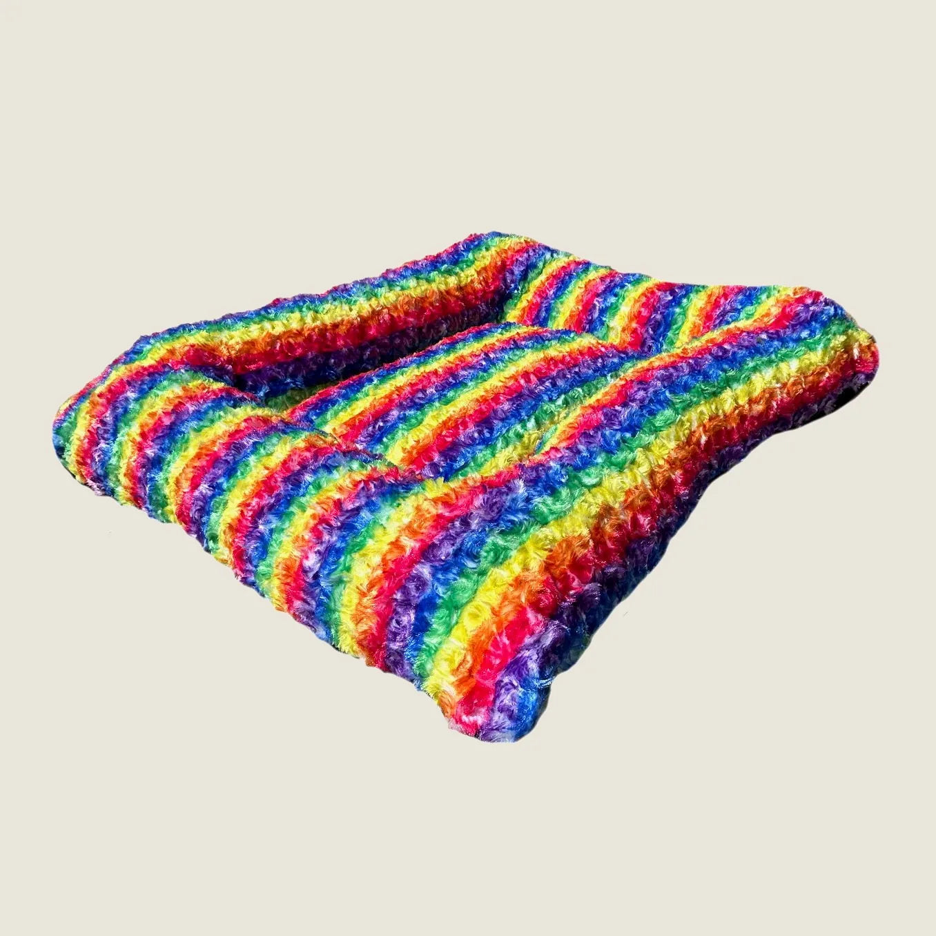 Rainbow-striped rectangle bolstered dog bed made from soft Minky Rose Fleece, perfect for cozy naps.
