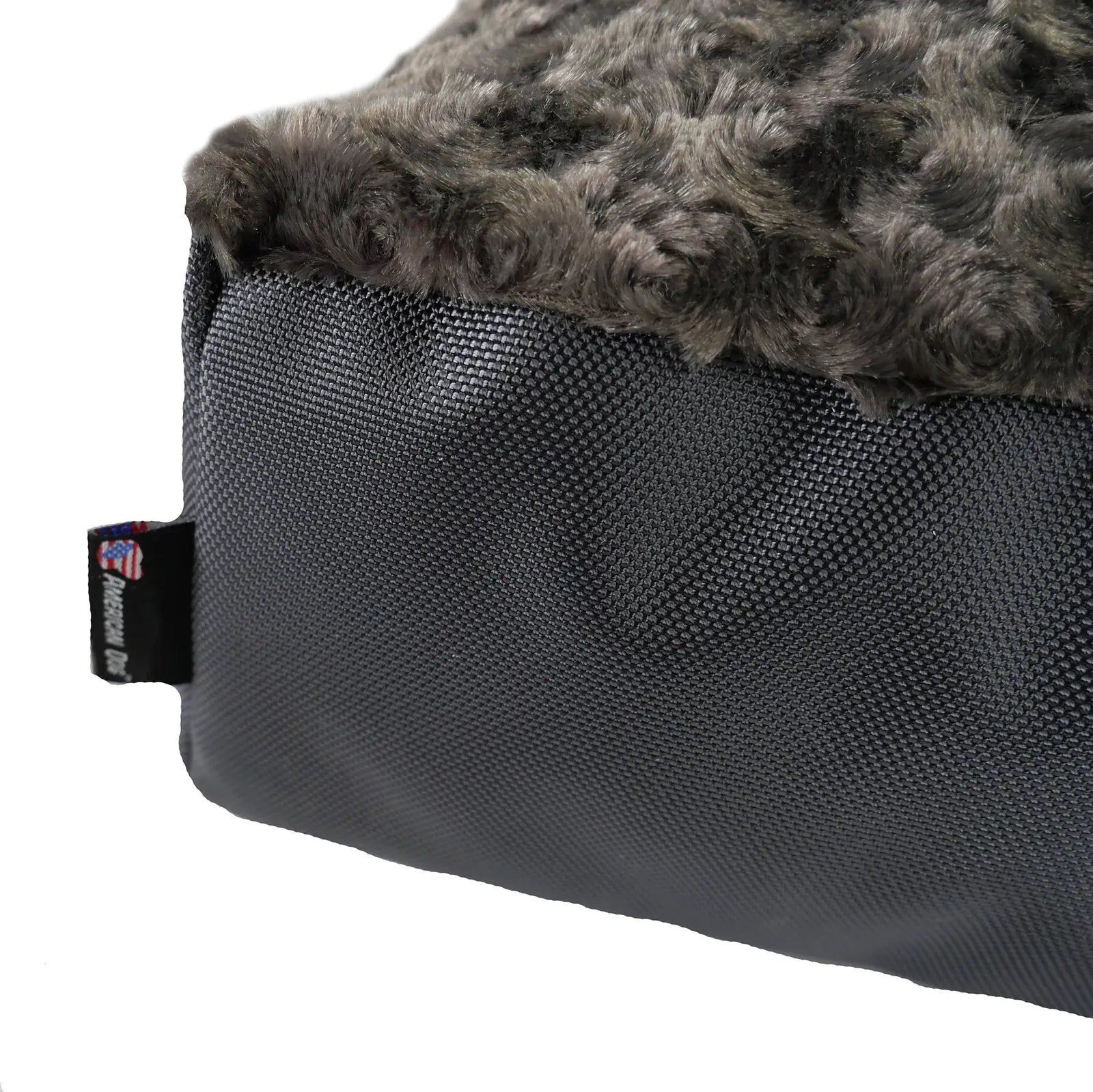 Gray orthopedic dog bed with a plush top and durable black nylon bottom, featuring the American Dog tag.
