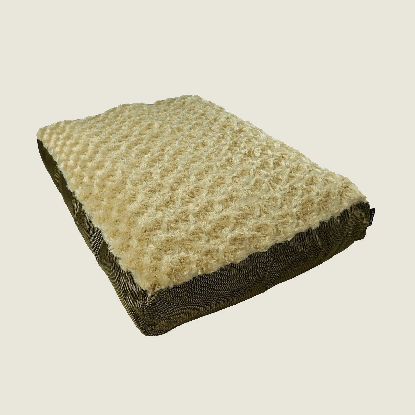 Orthopedic dog bed with a plush beige Minky Rose Fleece top and durable green nylon base, designed for comfort and support.