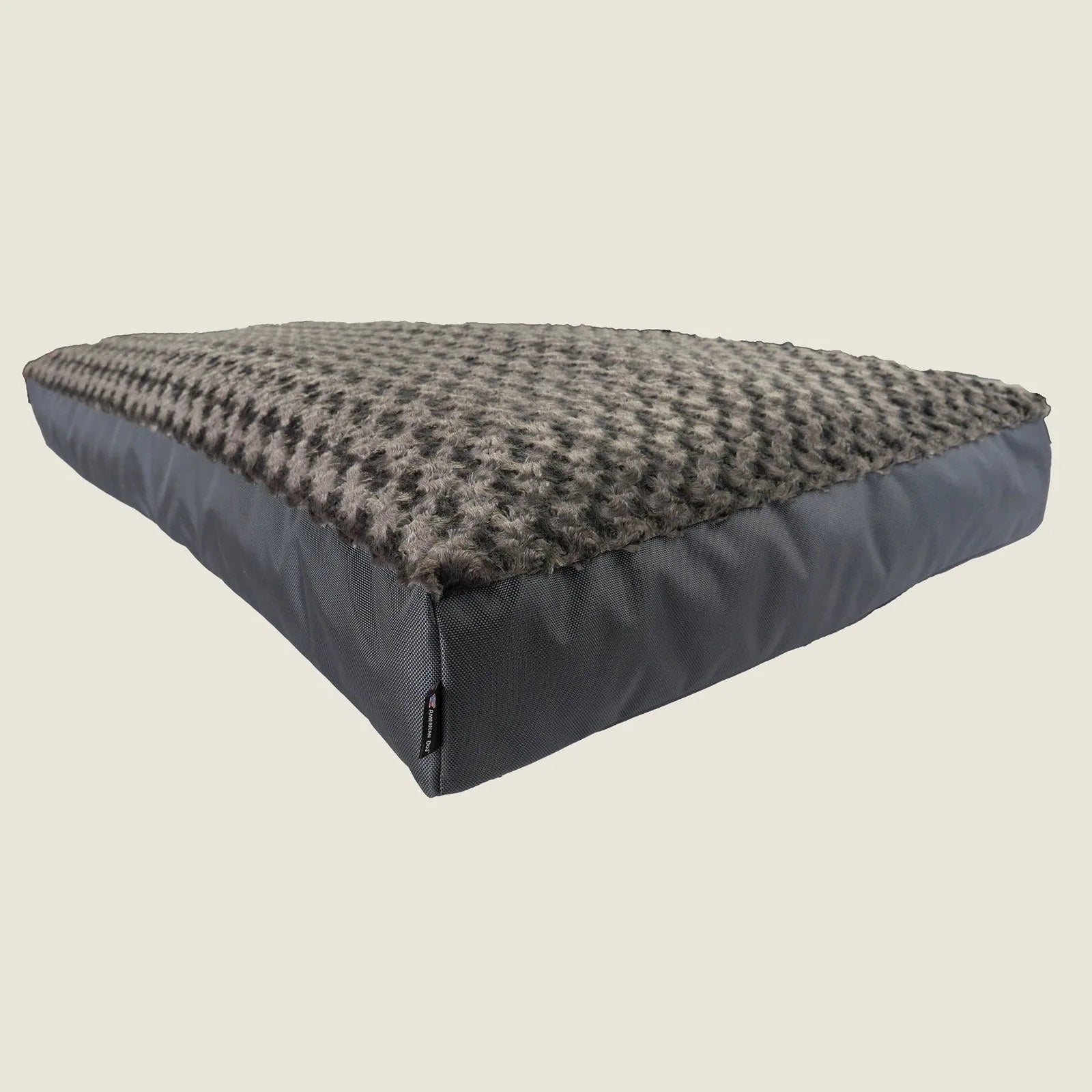 Orthopedic dog bed in charcoal with a plush top and durable fabric, providing comfort and support for dogs.