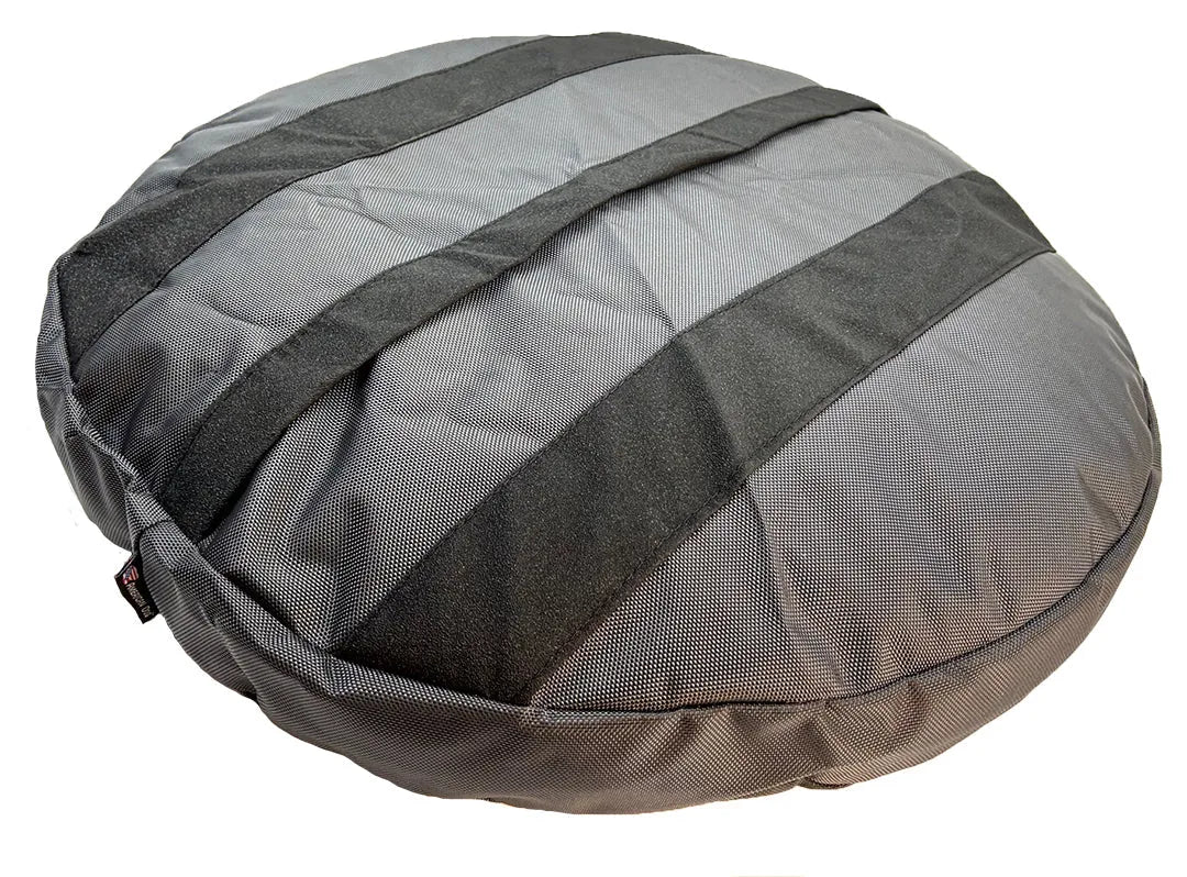 Round dog bed in black and gray nylon fabric with a textured surface, designed for durability and comfort.