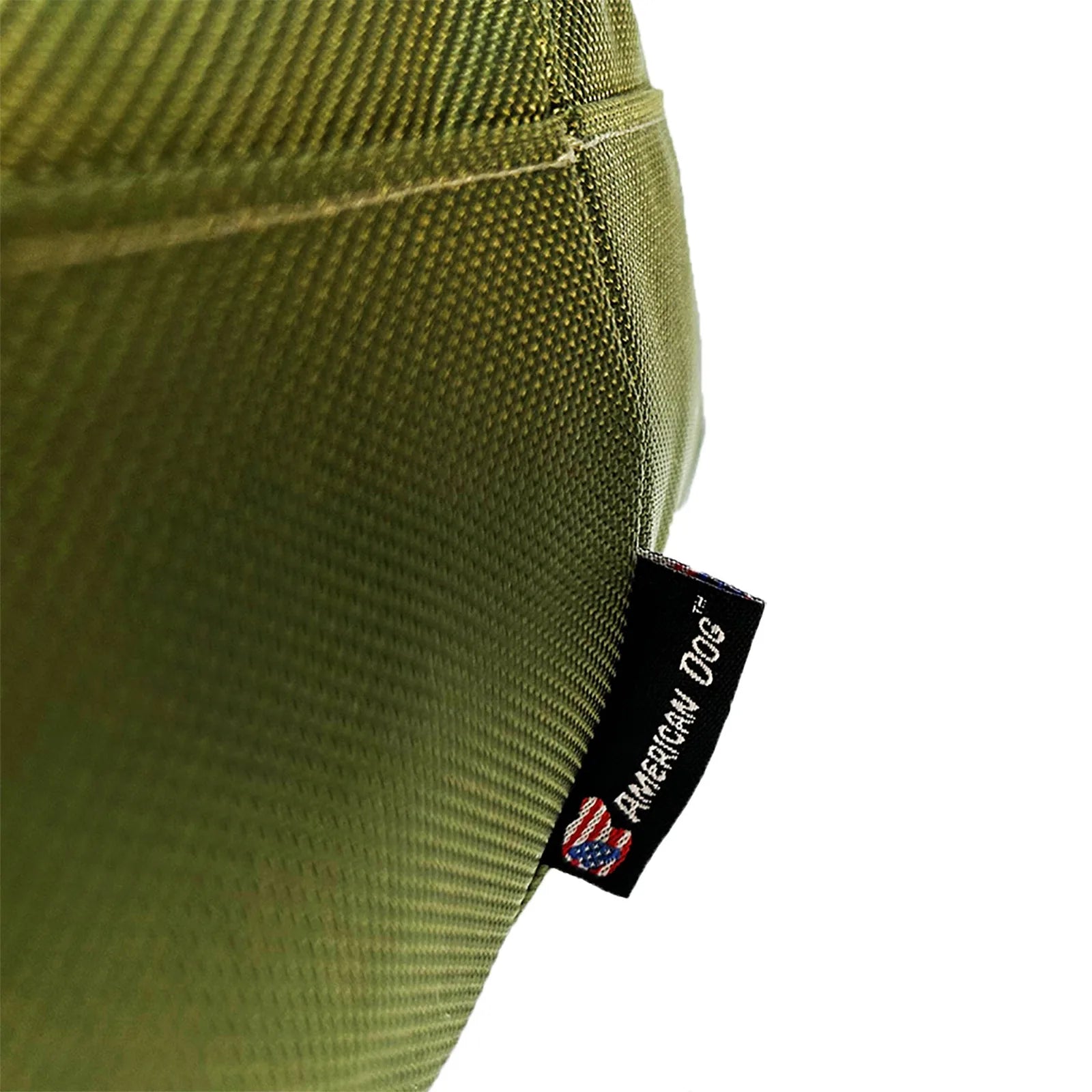 Round, olive dog bed corner with "American Dog" tag, showcasing a durable nylon fabric design.