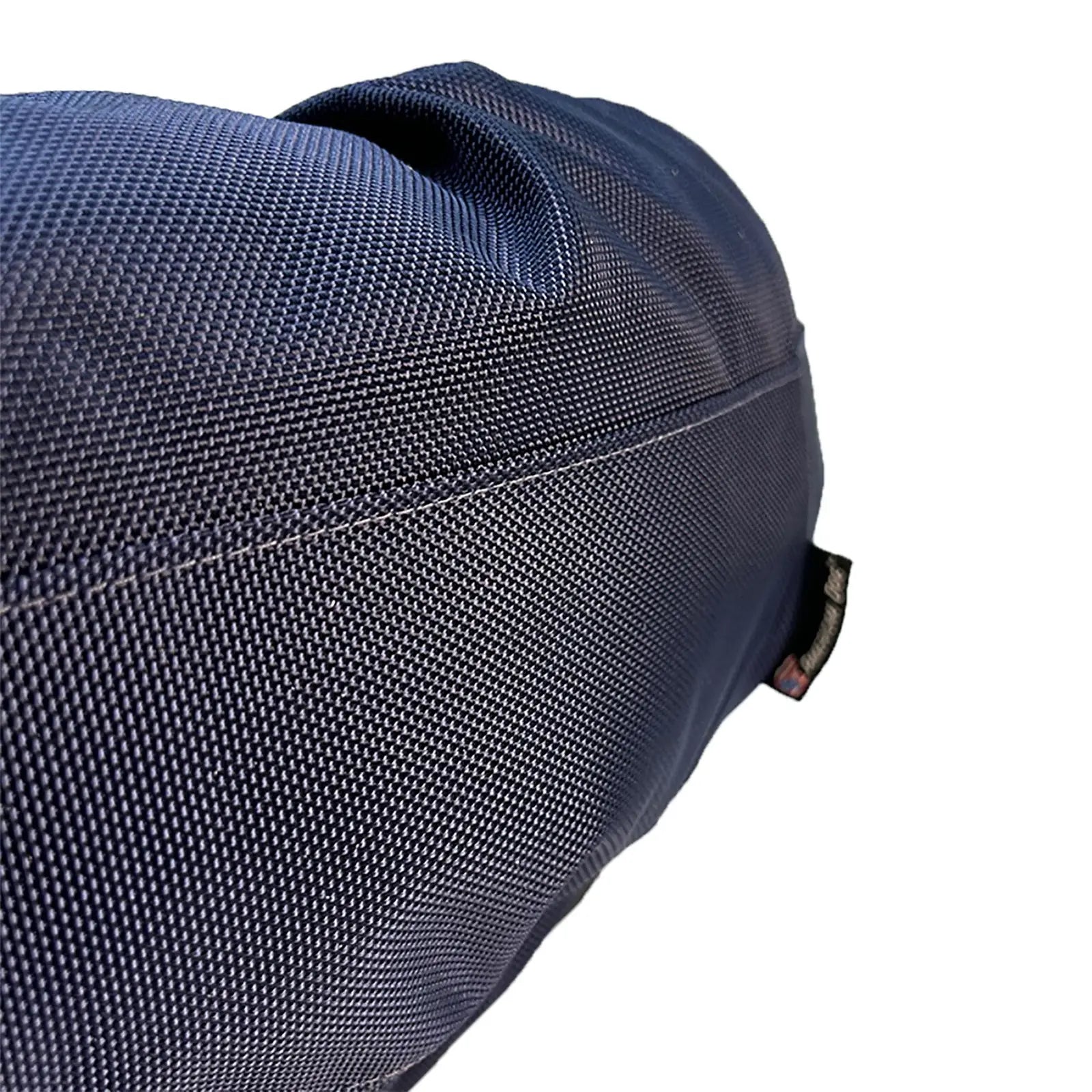 Round bolstered dog bed with textured charcoal nylon fabric, emphasizing durability and comfort for indoor and outdoor use.