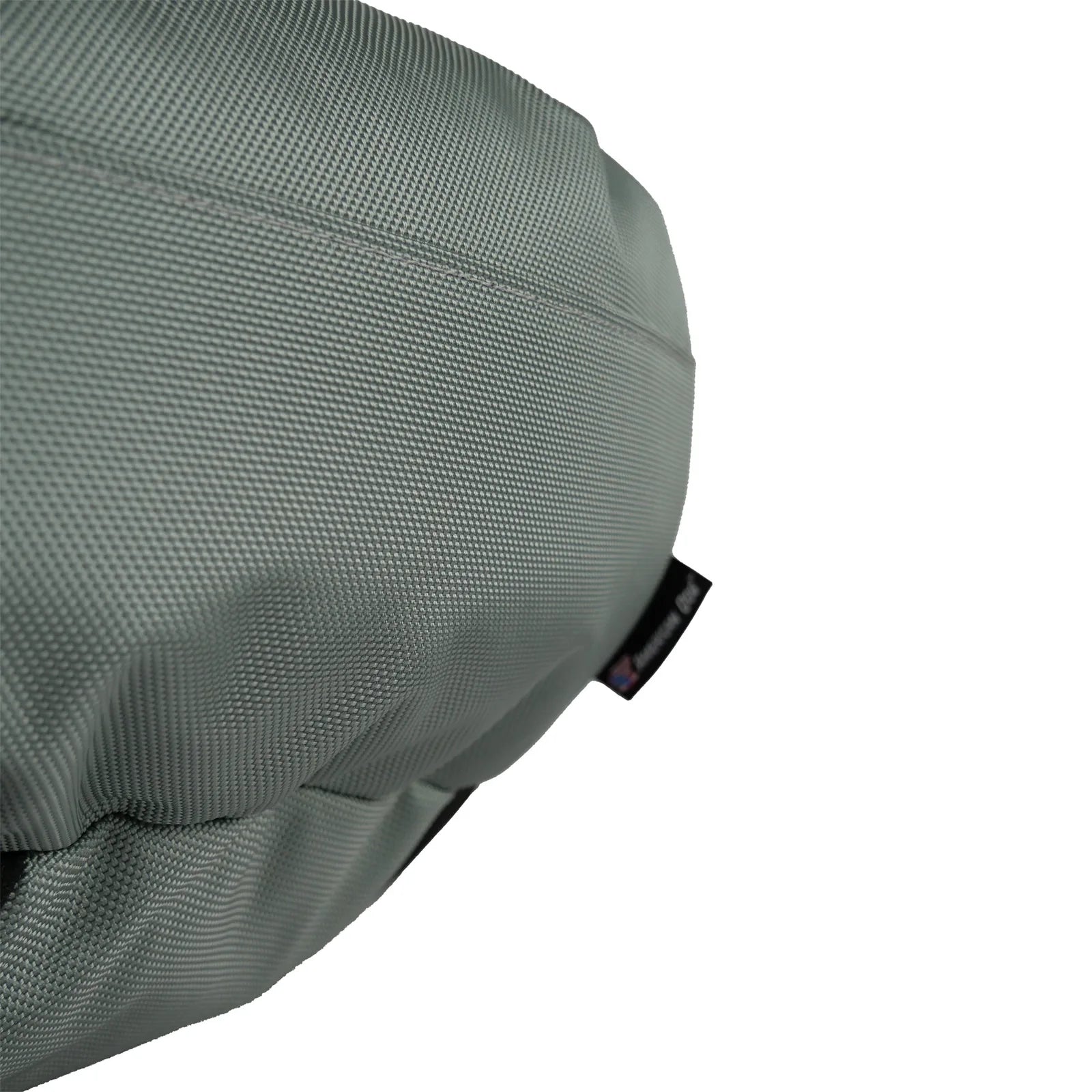 Close-up of a durable, gray dog bed featuring a textured nylon cover, showcasing its bolstered design and sturdy stitching.
