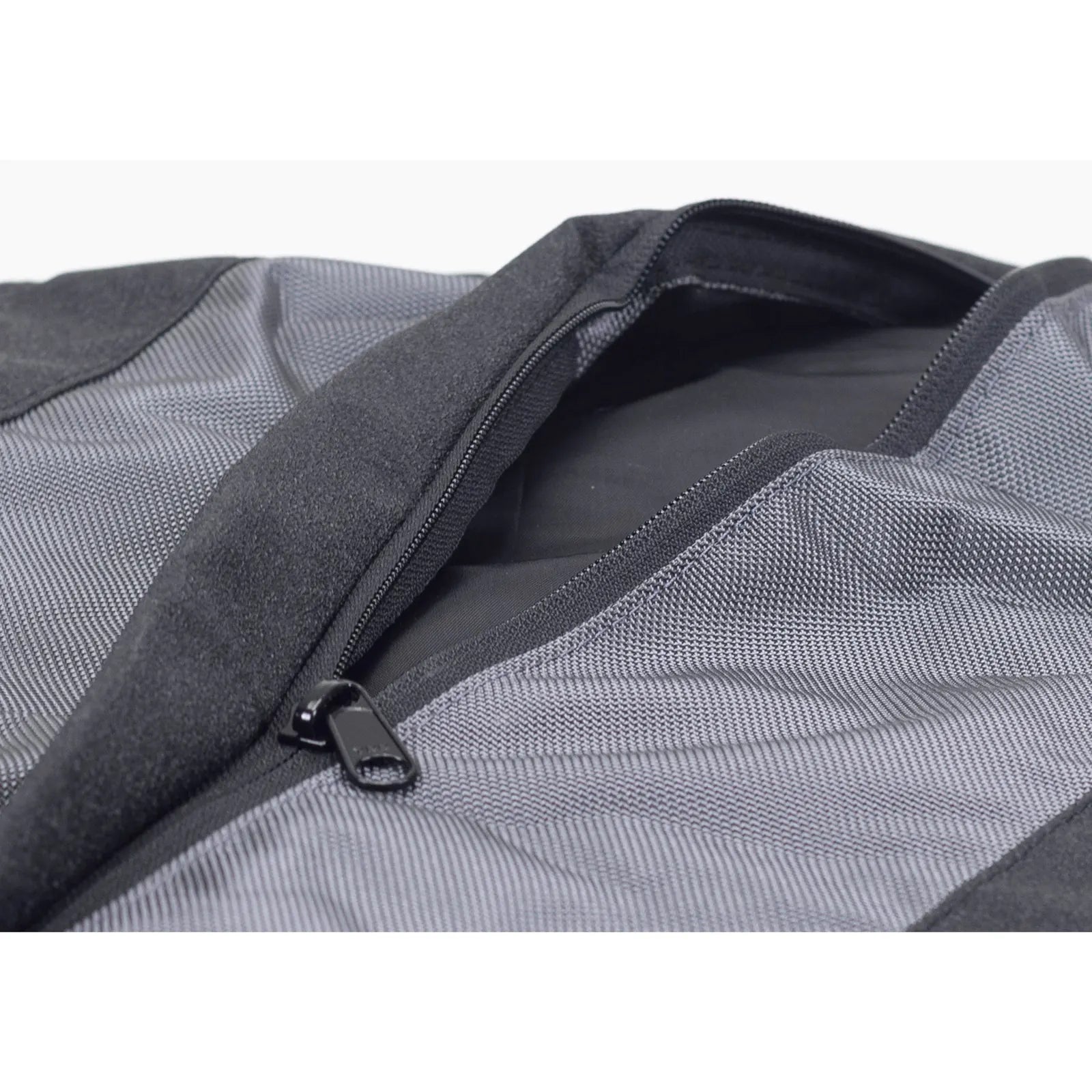 Close-up of black zipper on a soft, textured dog bed cover, showing durable stitching and sturdy fabric.