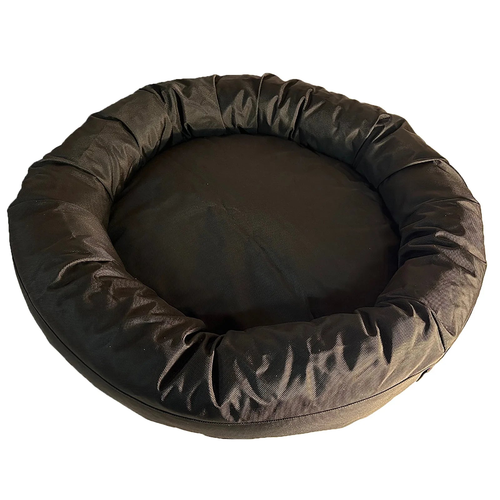 Round bolstered dog bed in black, featuring a durable nylon fabric cover with thick bolsters for comfort and support.