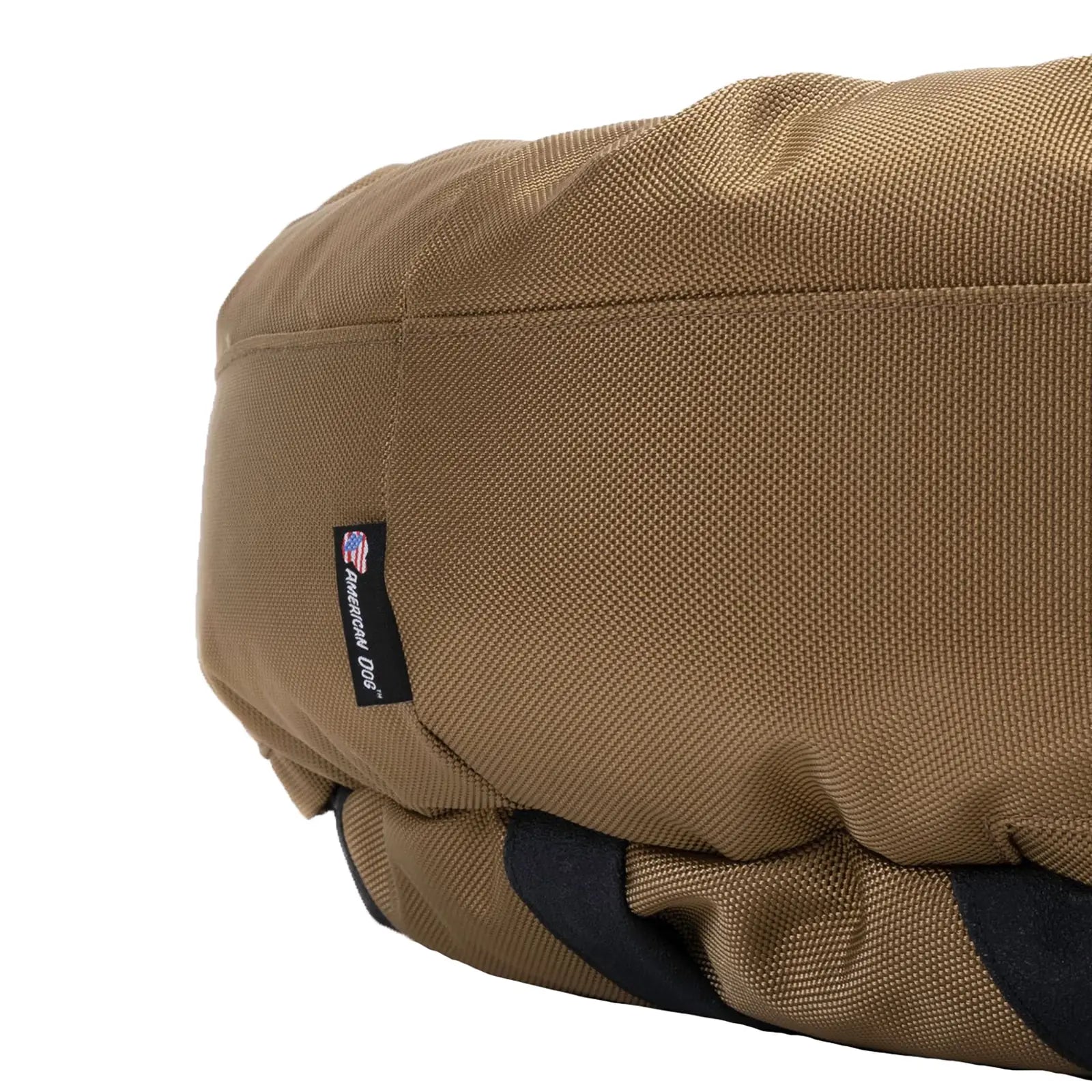 Round bolstered dog bed in camel color, featuring durable 1680D nylon fabric and an American Dog label.