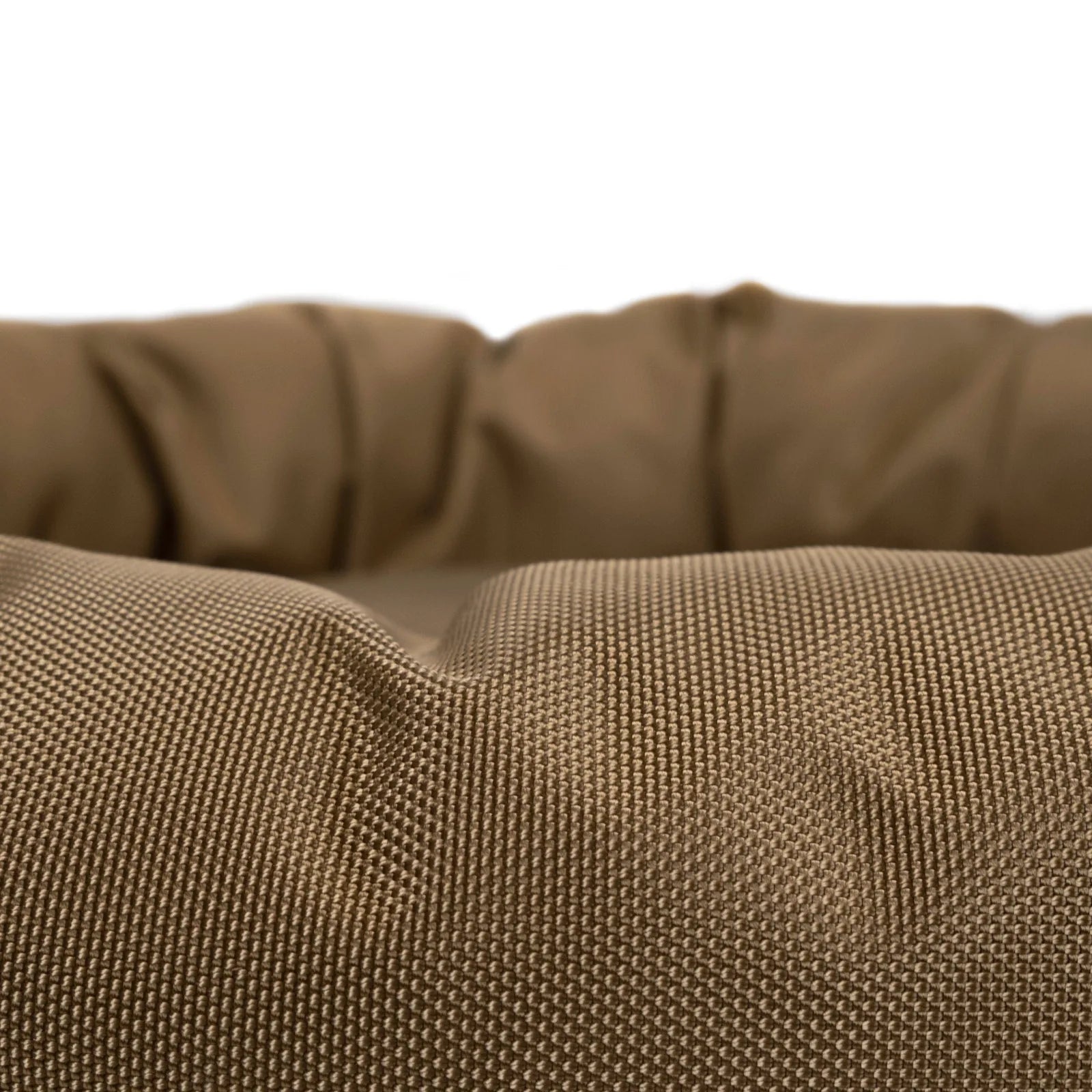 Close-up of the round bolstered dog bed in camel, featuring a durable, textured nylon fabric for comfort and style.