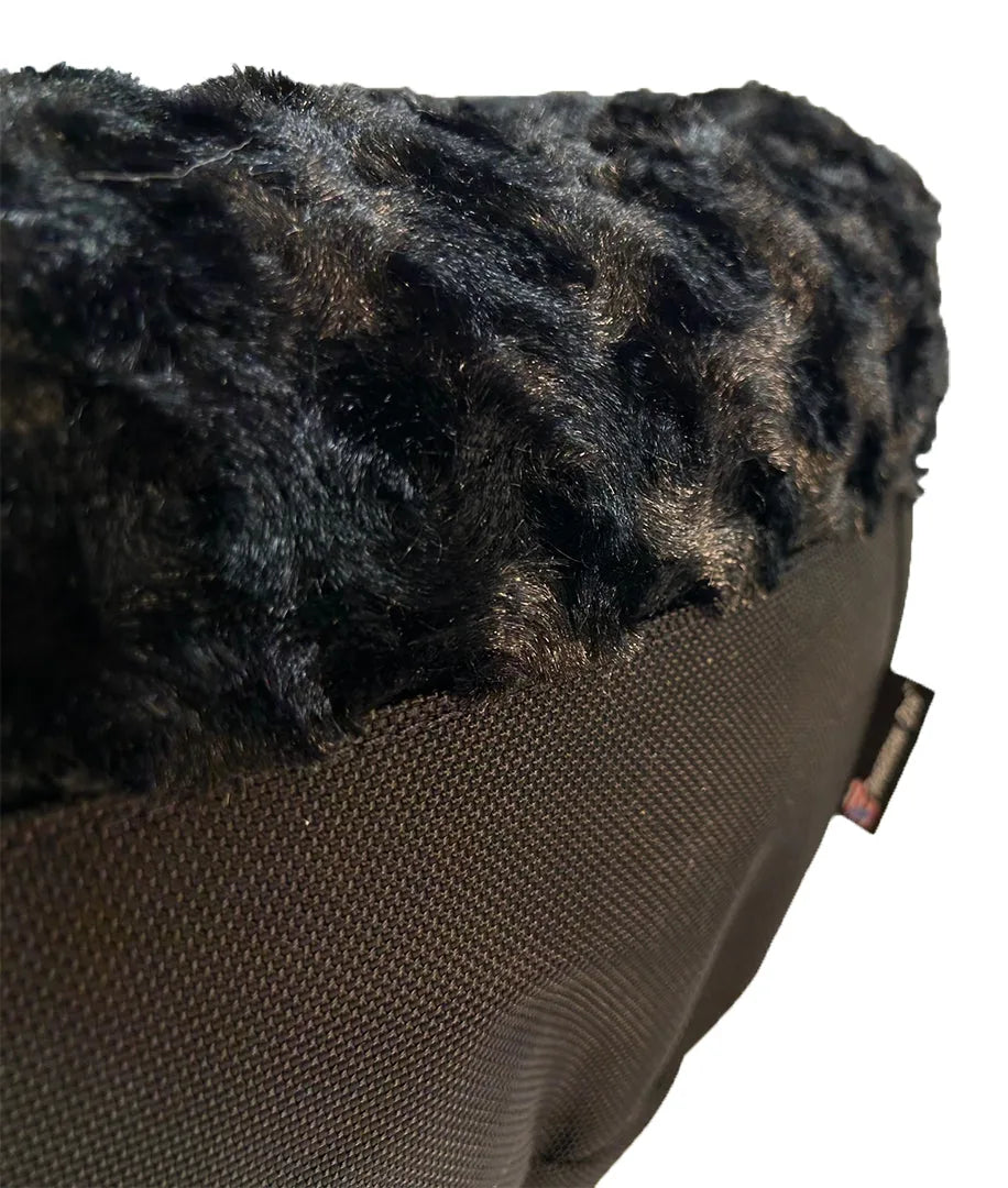 Close-up of the Round Bolstered Furvana™ Dog Bed in black, featuring a soft fur-like top and durable nylon bottom fabric.