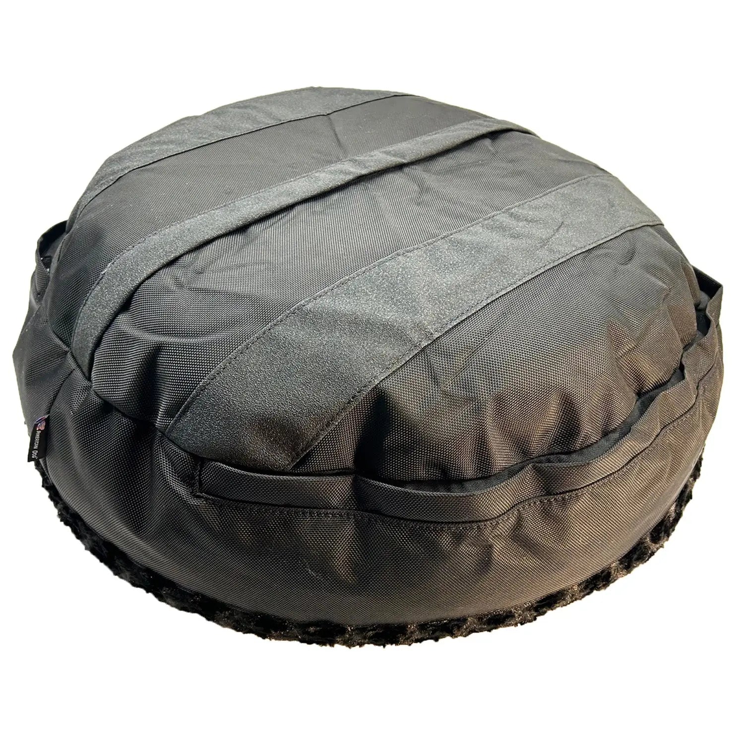Round bolstered dog bed in sleek black fabric with soft fleece trim, featuring a durable, non-skid bottom.