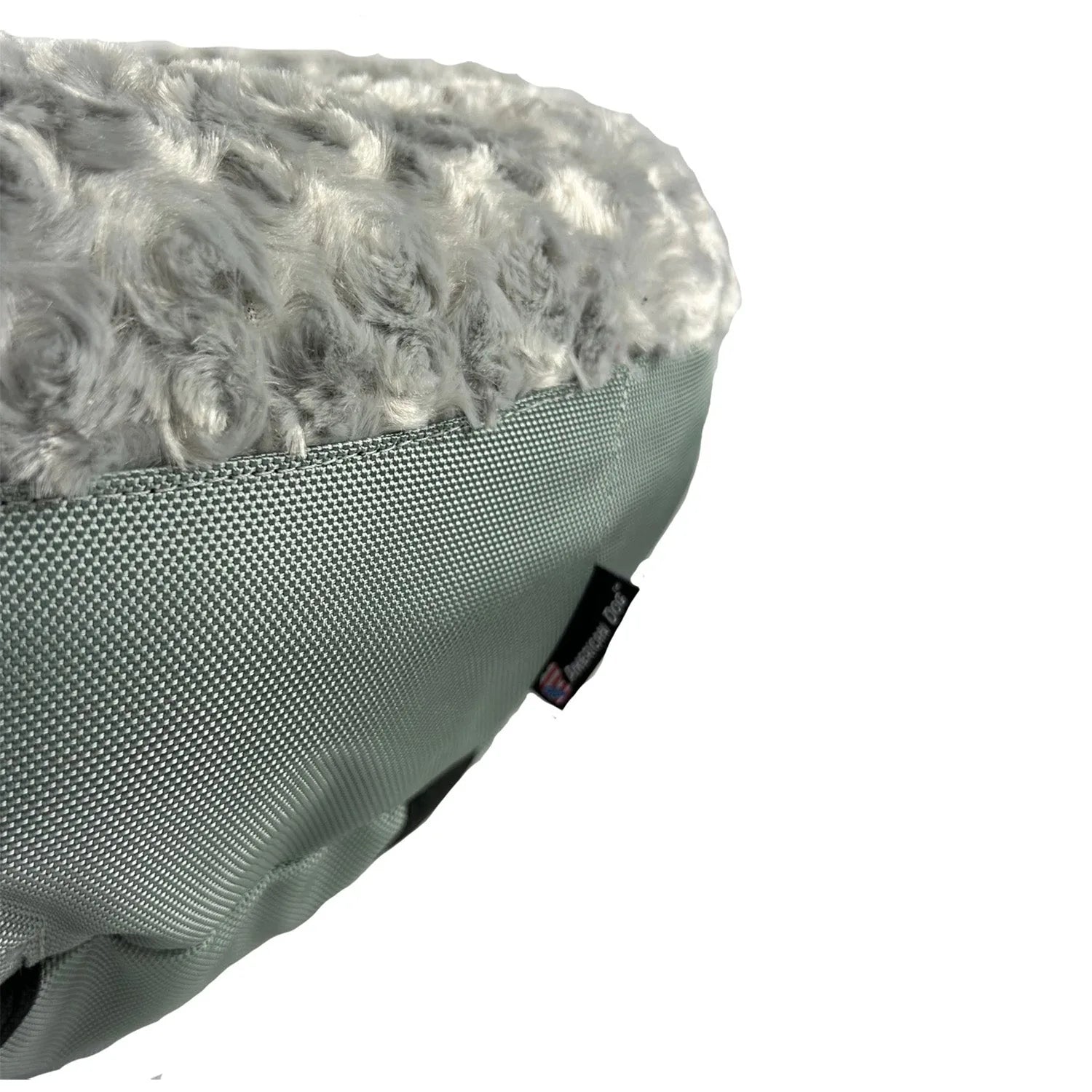 Soft gray round dog bed featuring a plush, curly fleece top and durable nylon base for comfort and stability.