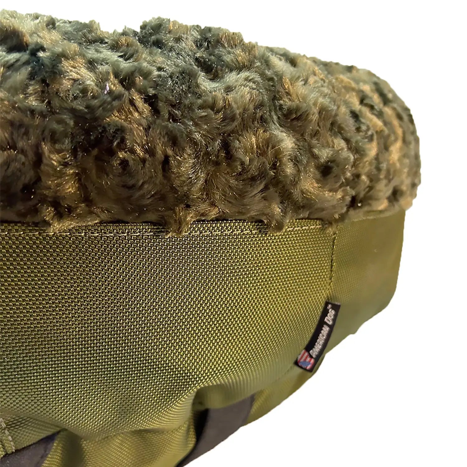 Round bolstered dog bed featuring soft olive green Minky fleece and sturdy nylon fabric for durability and comfort.