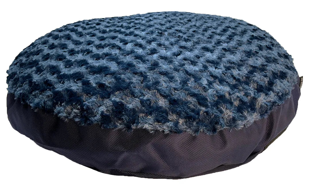Round Furvana Dog Bed in dark blue, featuring a soft Minky Rose Fleece top and sturdy nylon bottom for durability.
