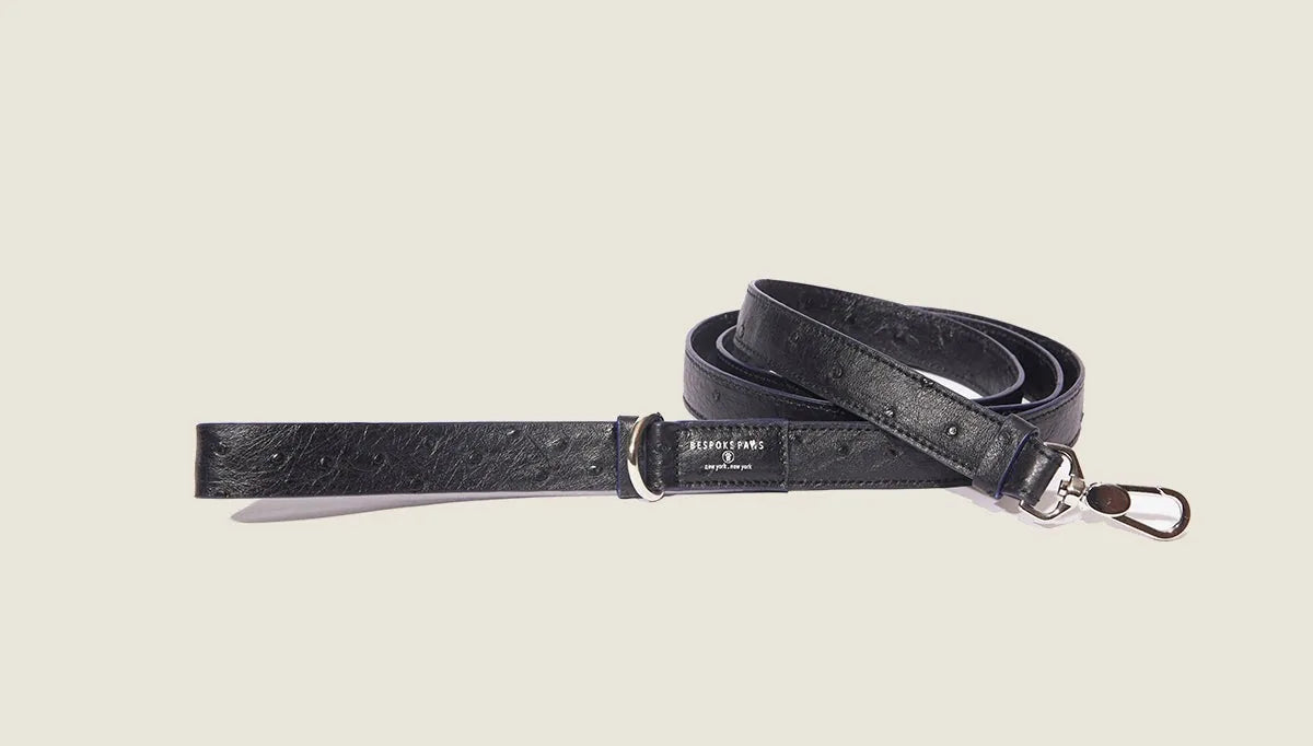 Textured black ostrich-inspired dog leash with ultramarine leather edges, featuring a padded handle and secure clasp.