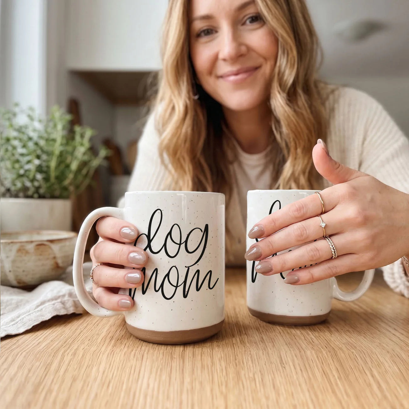 16oz off-white ceramic mug with "Dog Mom" graphic, featuring dark speckles and a light beige stoneware base.