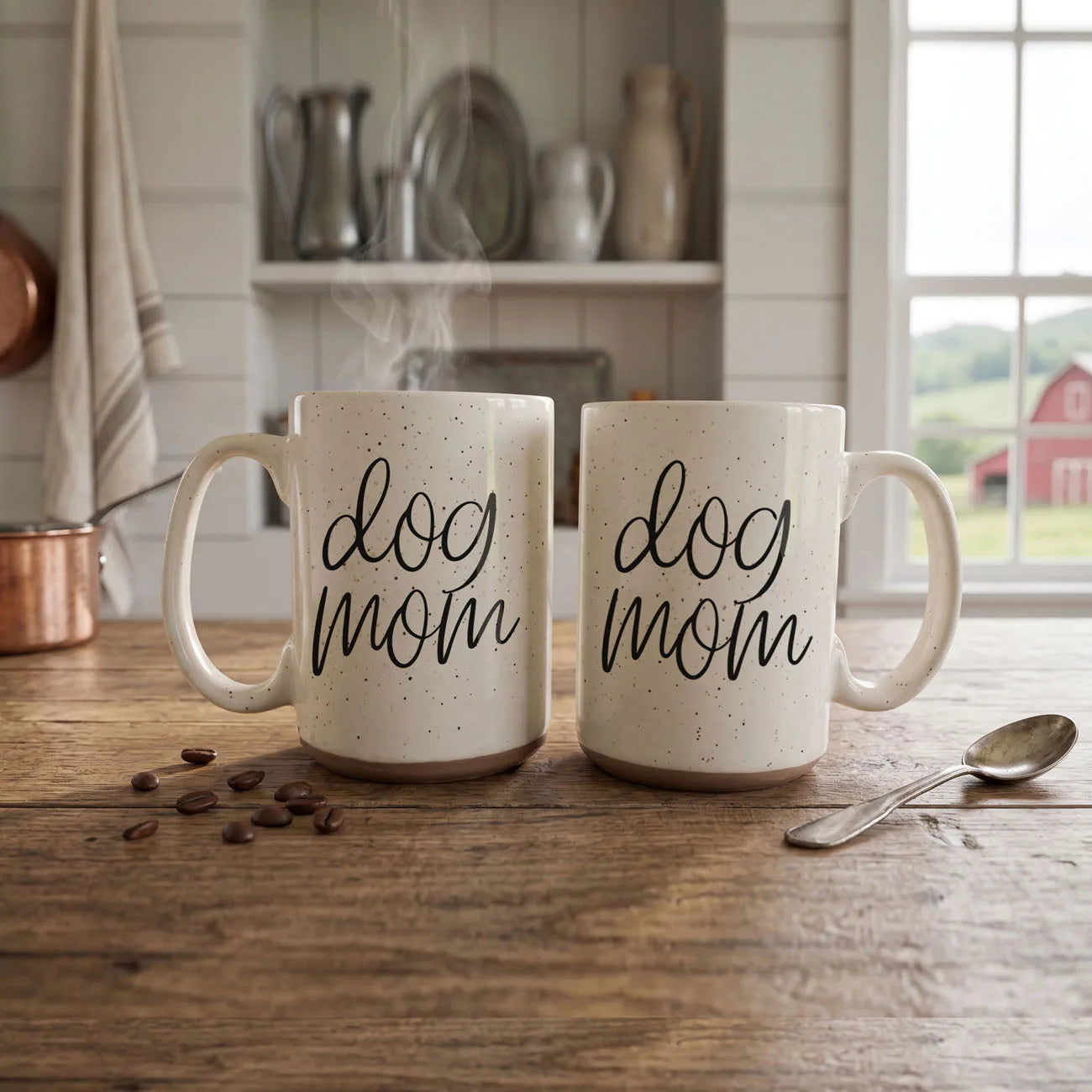 Off-white ceramic mug with dark speckles, featuring "dog mom" graphic, sitting on a wooden table with coffee beans.