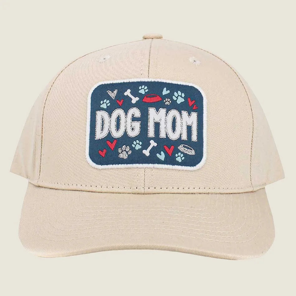 Beige adjustable baseball cap featuring "DOG MOM" embroidery with colorful paw prints and hearts.