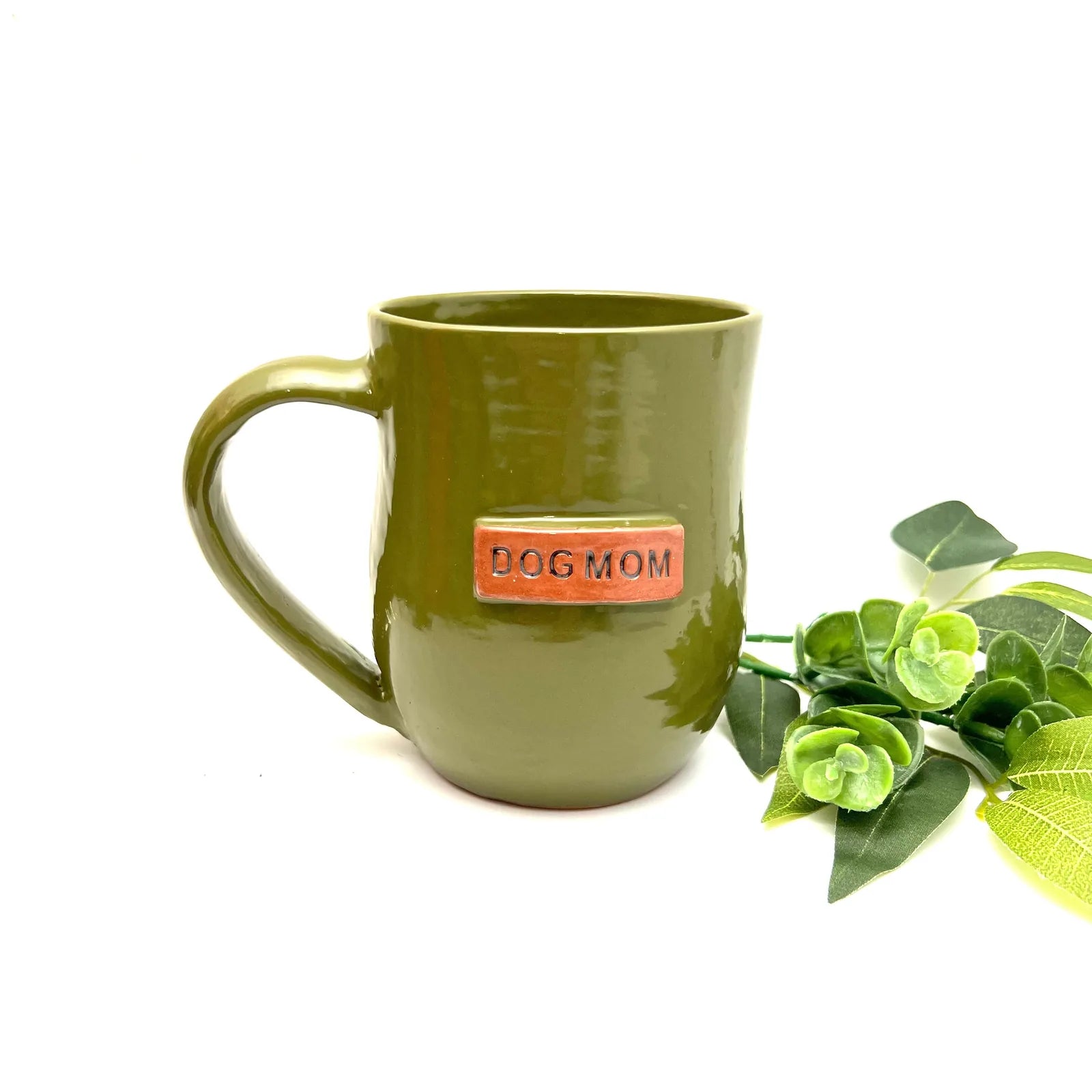 Handmade frog pond green ceramic mug with "DOG MOM" engraving and sturdy handle, perfect for dog-loving coffee drinkers.