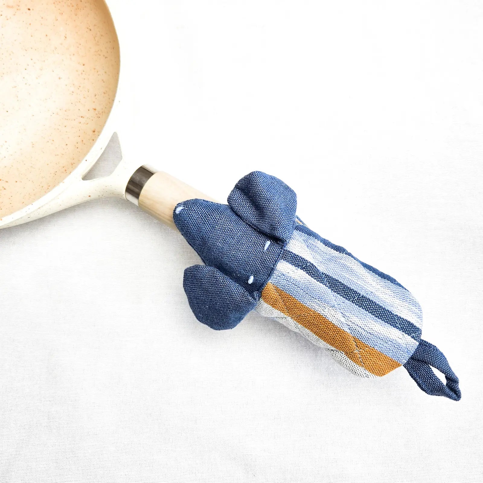 Dog Skillet Handle Holder in blue, featuring a playful dog design and colorful stripes, made from heat-resistant cotton.