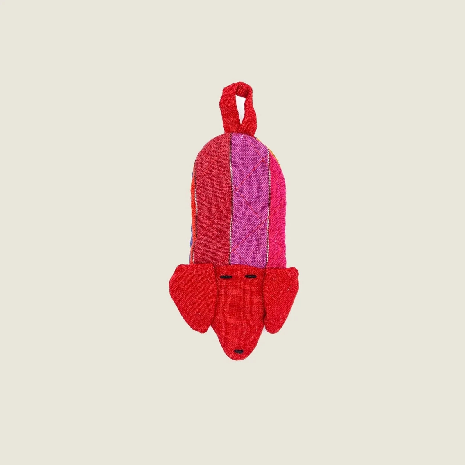 Bright red dog-shaped skillet handle holder with a colorful striped pattern, made from 100% cotton for heat resistance.